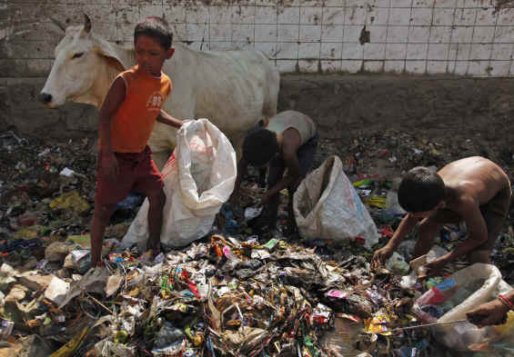 Kids picking up recyclables from trash Kids picking up recyclables from trash